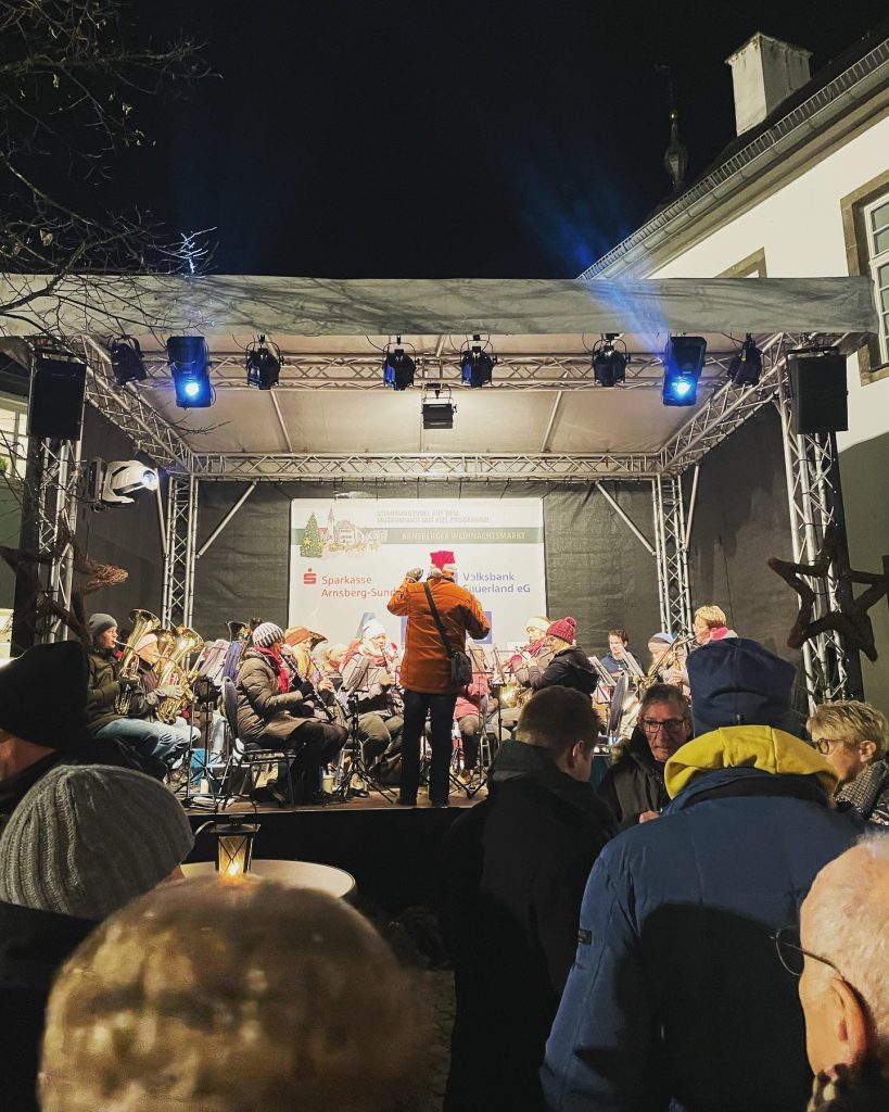 Publikum vor der beleuchteten Bühne auf dem Arnsberger Weihnachtsmarkt 2022